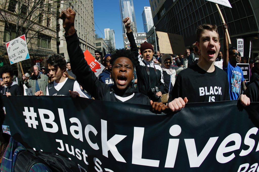 Bryce Green, 12, center, takes part in a Black Lives Matter protest march with his friend Danilo Petrovic, 13, right, and others in April 2017 in Seattle. Several thousand people attended a downtown rally and then marched to the federal courthouse to call attention to minority rights and police brutality. 