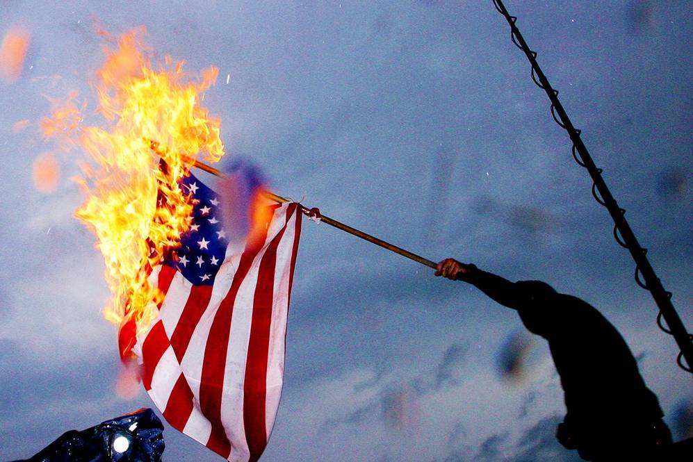 A man burns a U.S. flag in Copenhagen, Denmark, to protest the arrival of U.S. President George W. Bush in July 2005.