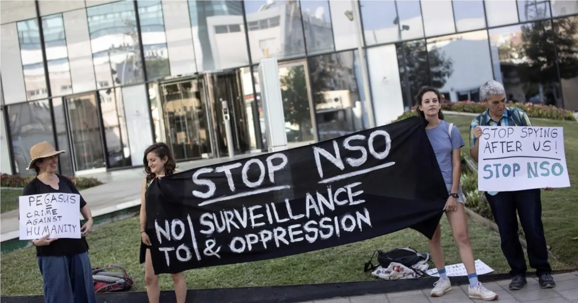 Protesters stand outside the office of NSO Group, the developer of Pegasus, near Tel Aviv, Israel, on July 25, 2021.